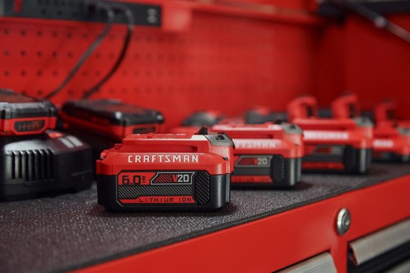 Photo of Craftsman V20 lithium ion battery CMCB206, 6.0Ah, red and black, on tool bench.
