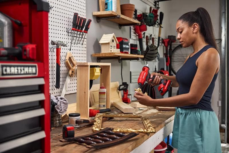 Photo of Craftsman CMGL200 cordless glue gun in use on a wood project in a workshop, tools visible on white background.