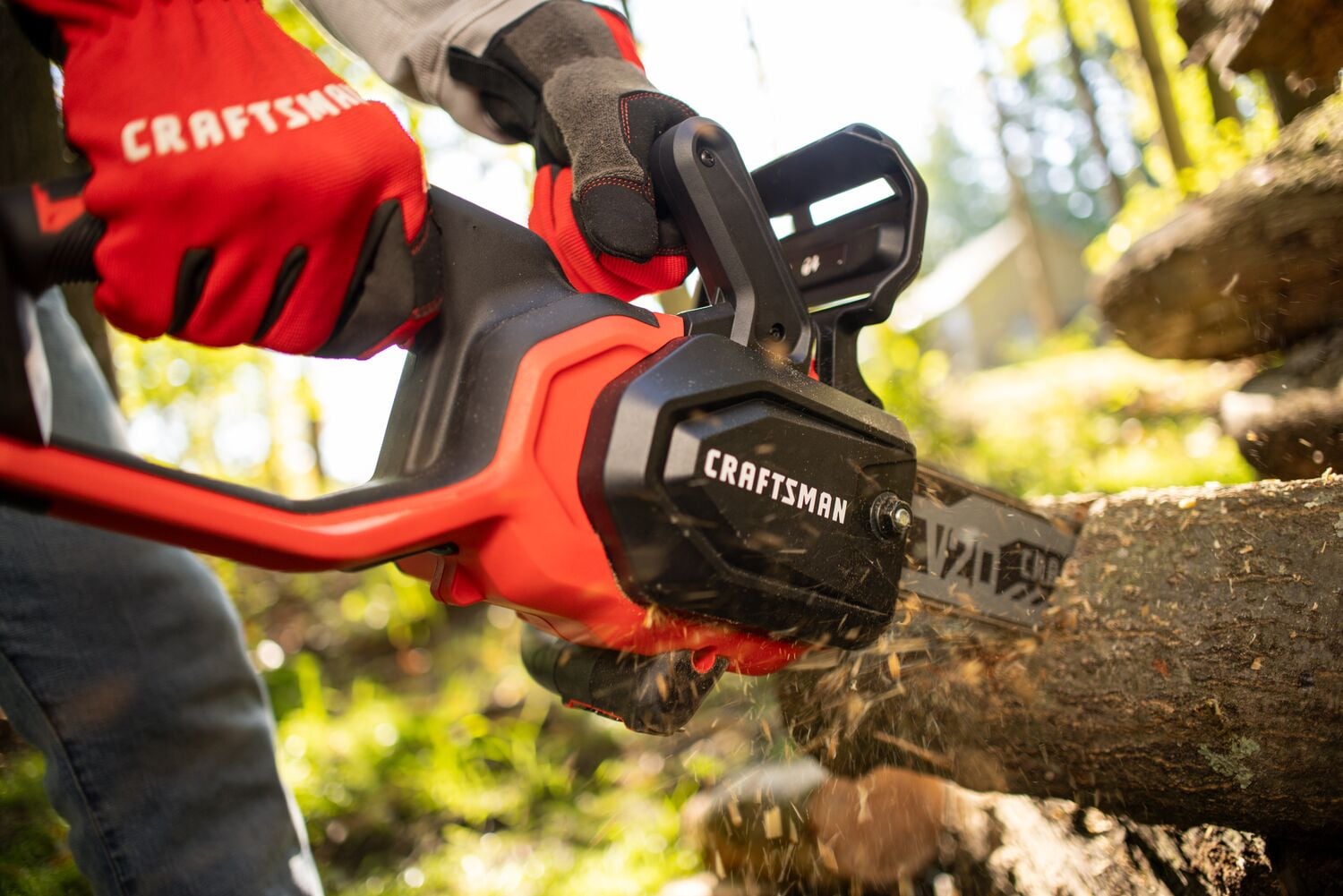 Zoom in of male cutting with V20 Chainsaw 