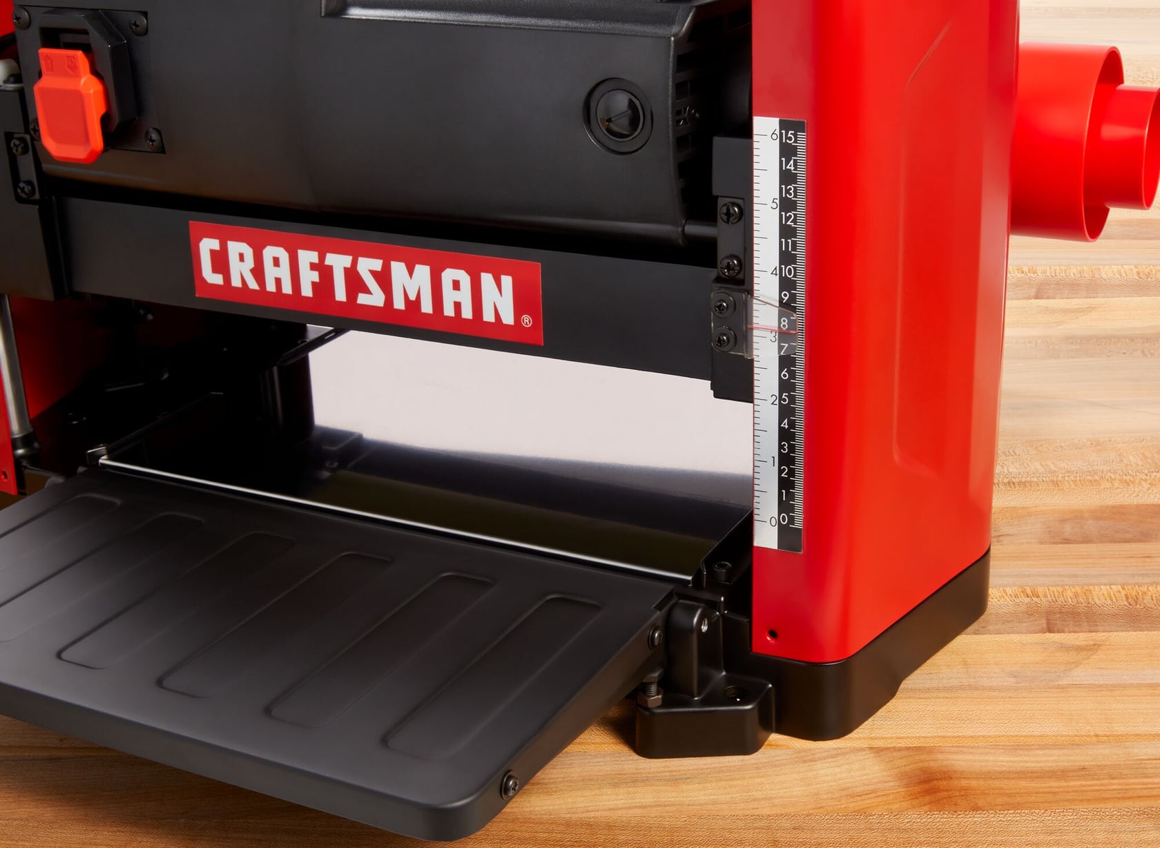 Close-up photo of Craftsman benchtop planer CMEW320 on wood surface showing measurement scale.