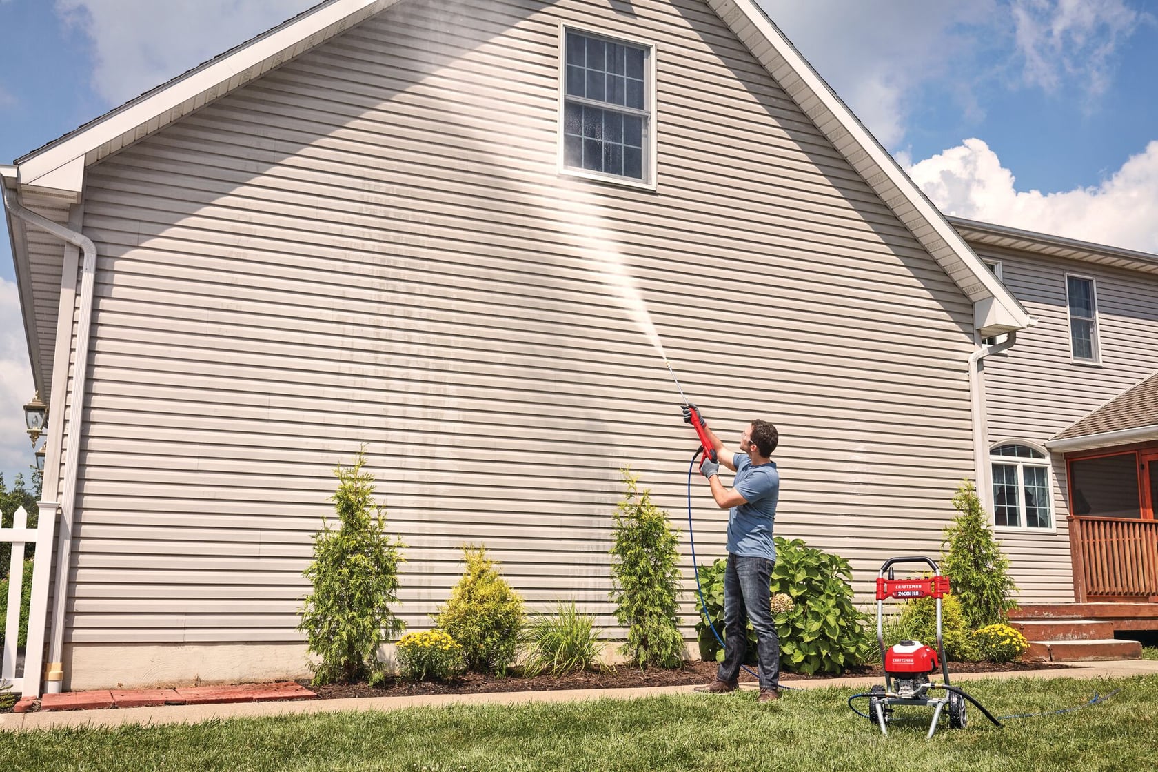 2400 pound per square inch electric cold water pressure washer being used by a person.