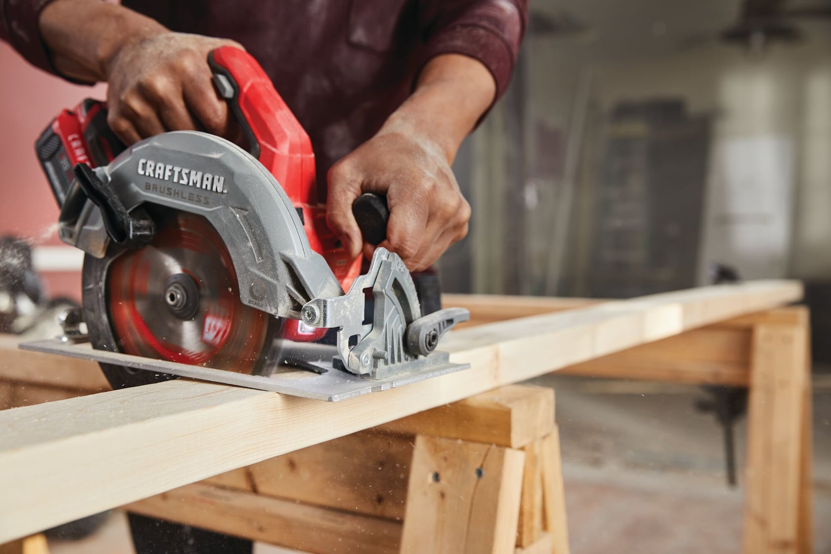 Photo of CRAFTSMAN CMCS550B circular saw cutting wood, featuring a red and gray brushless cordless design.