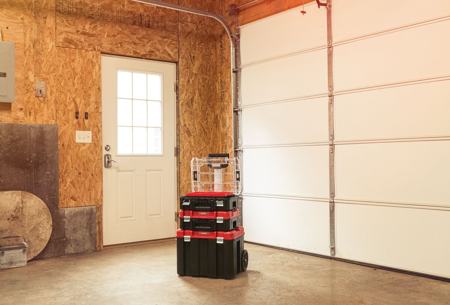 Photo of Craftsman rolling toolbox stack CMST60403 with black, red, and clear storage boxes in a garage.