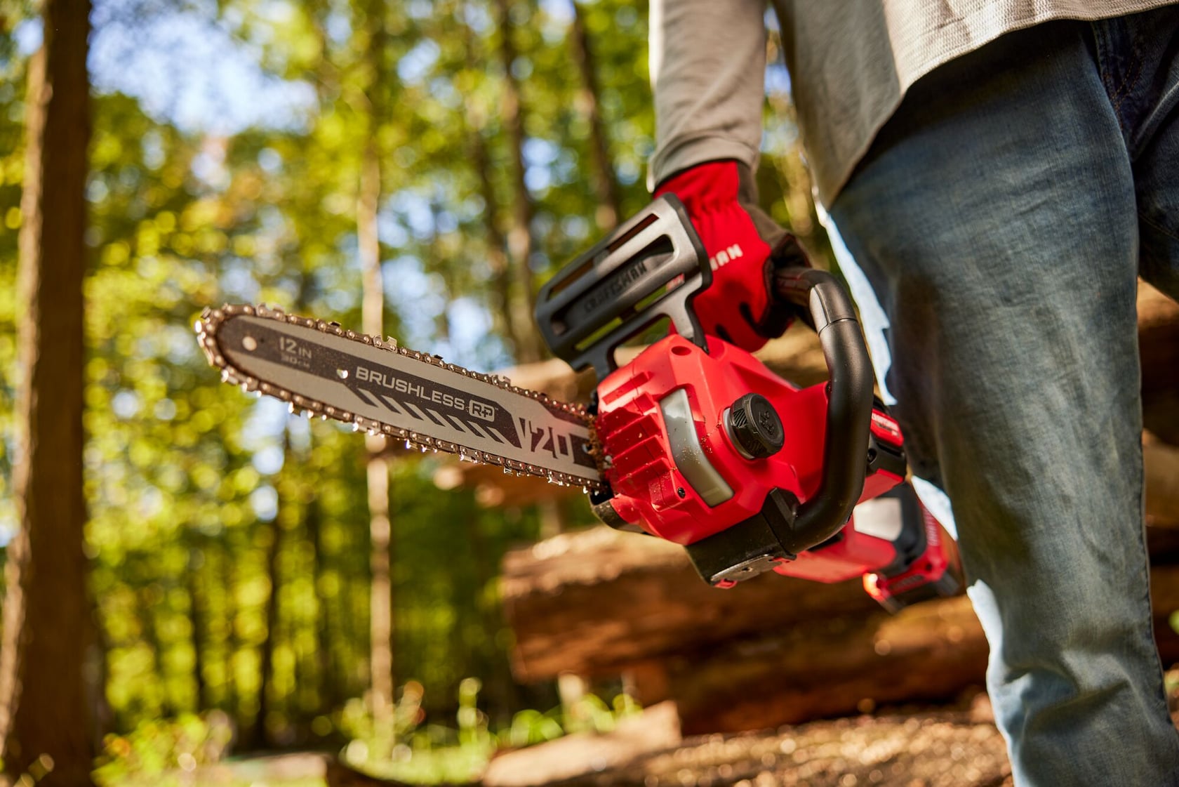 Zoom in of male holding V20 chainsaw 