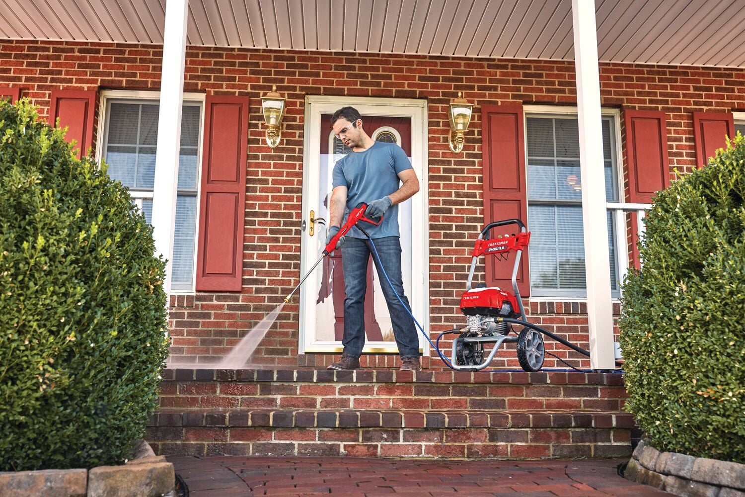 2400 pound per square inch electric cold water pressure washer being used by a person.