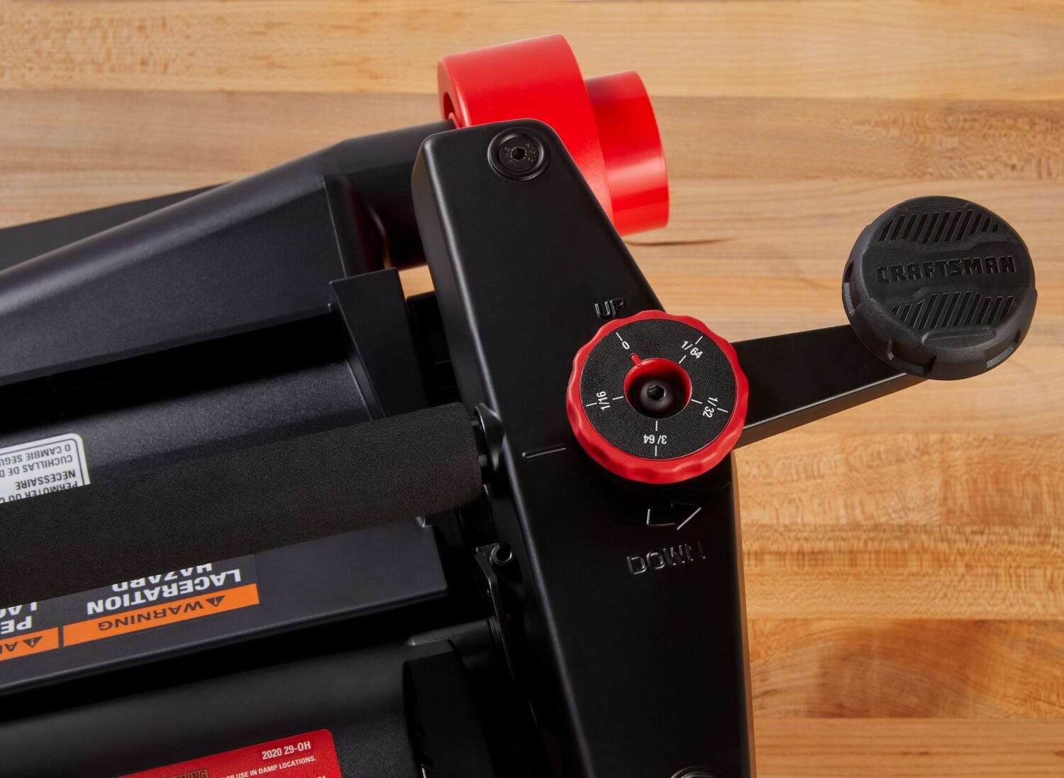 Photo of Craftsman benchtop jointer SKU CMEW320 control handle and adjustment knob, close-up on wooden surface.