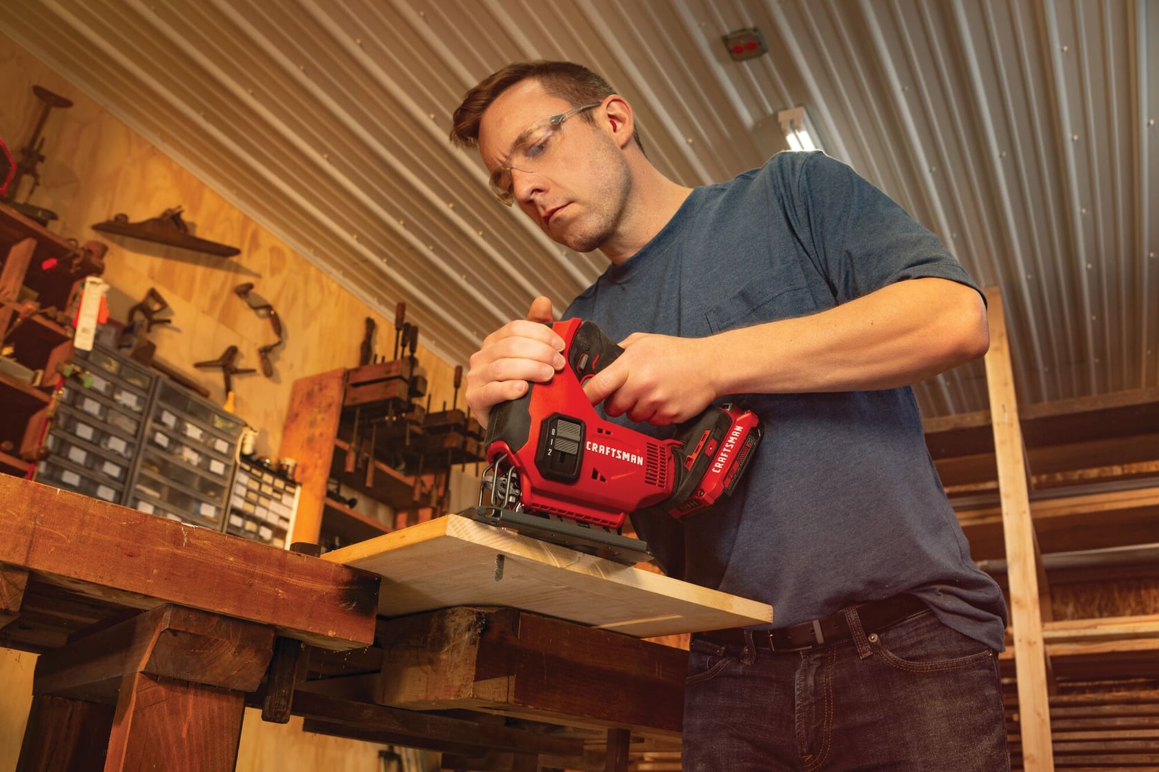 20 volt cordless jig saw kit being used by a person to cut wood indoors.