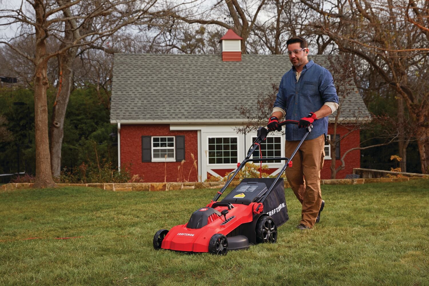 13 amp 20 inch corded 3 in 1 lawn mower being used by a person.