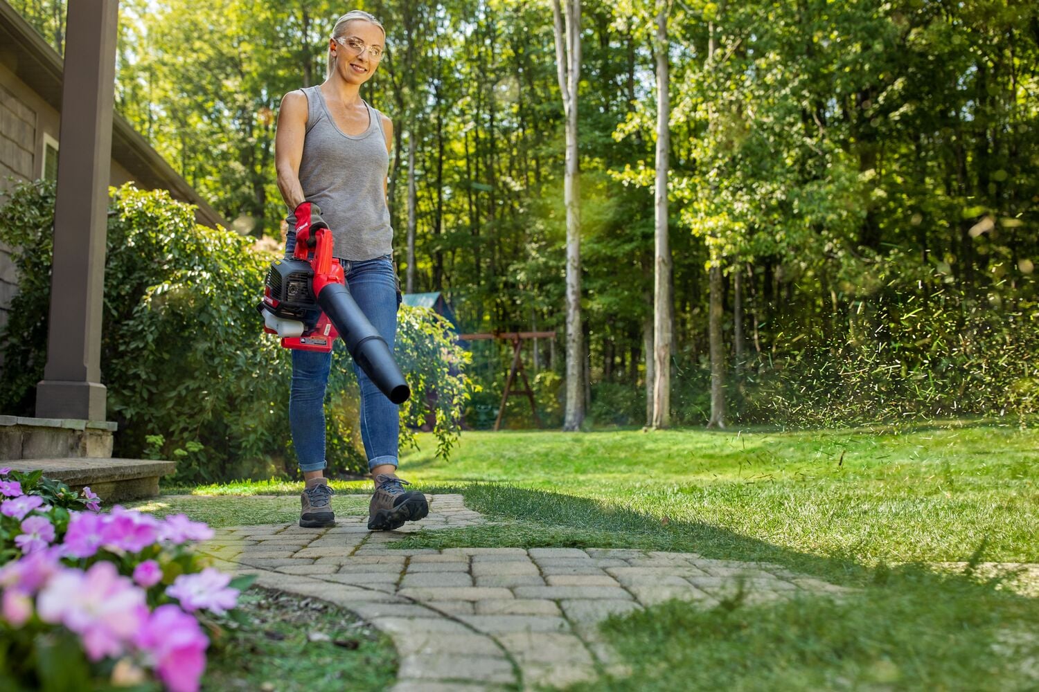 CRAFTSMAN B2000 gas leaf blower blowing patio with gray tank top 