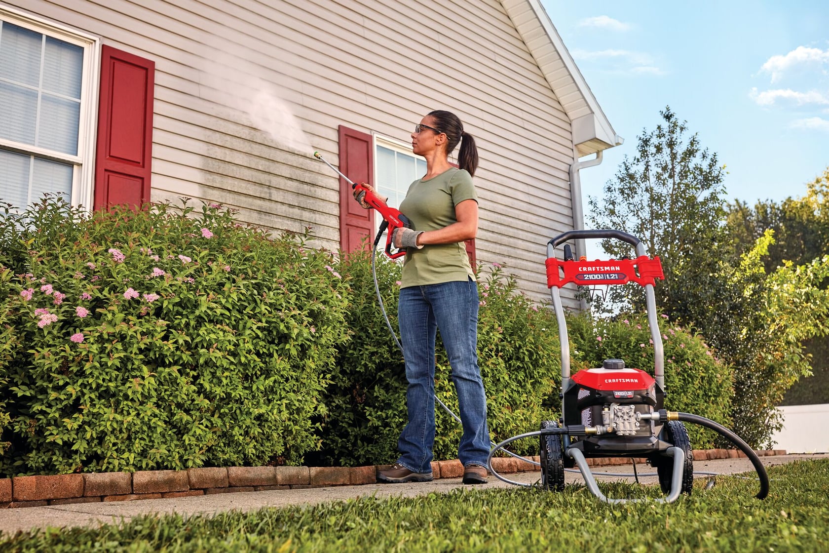 2100 pound per square inch electric cold water pressure washer being used by a person.