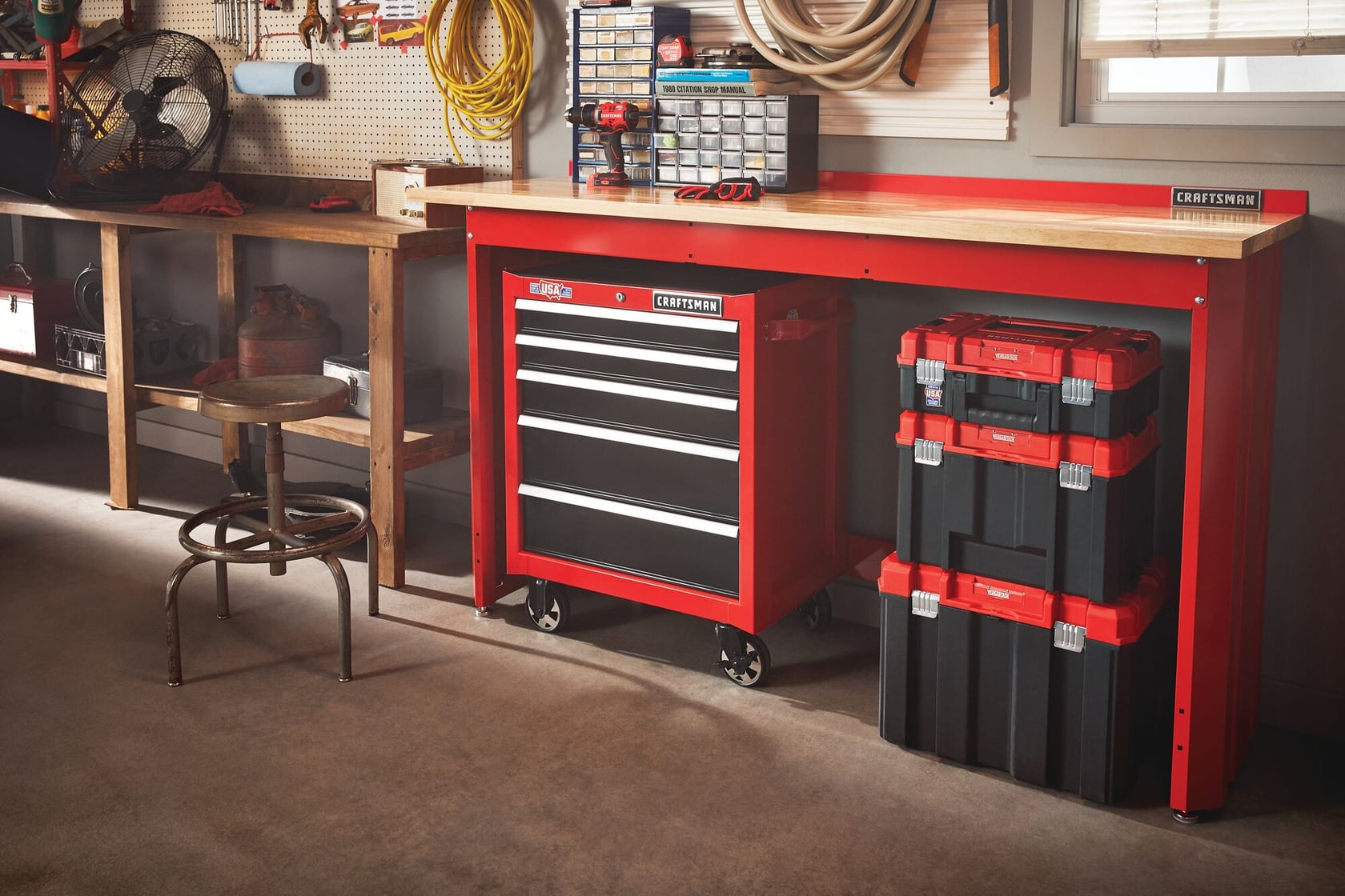 6 foot wide Workbench with Butcher Block Top accommodating tool cabinets chests and organizers under and on top of it in a garage workshop.