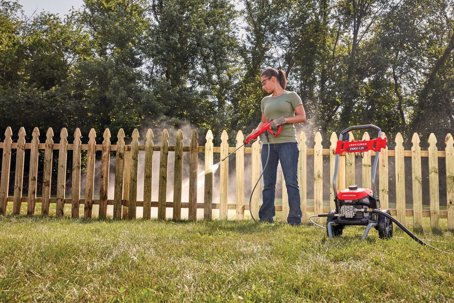 2100 pound per square inch electric cold water pressure washer being used by a person.