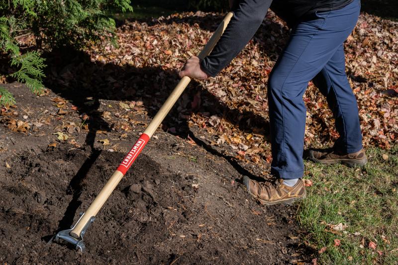 Long Handle Stirrup Shaped Steel Weed Cutting Scuffle Hoe with wood handle and cushion grip, in action 