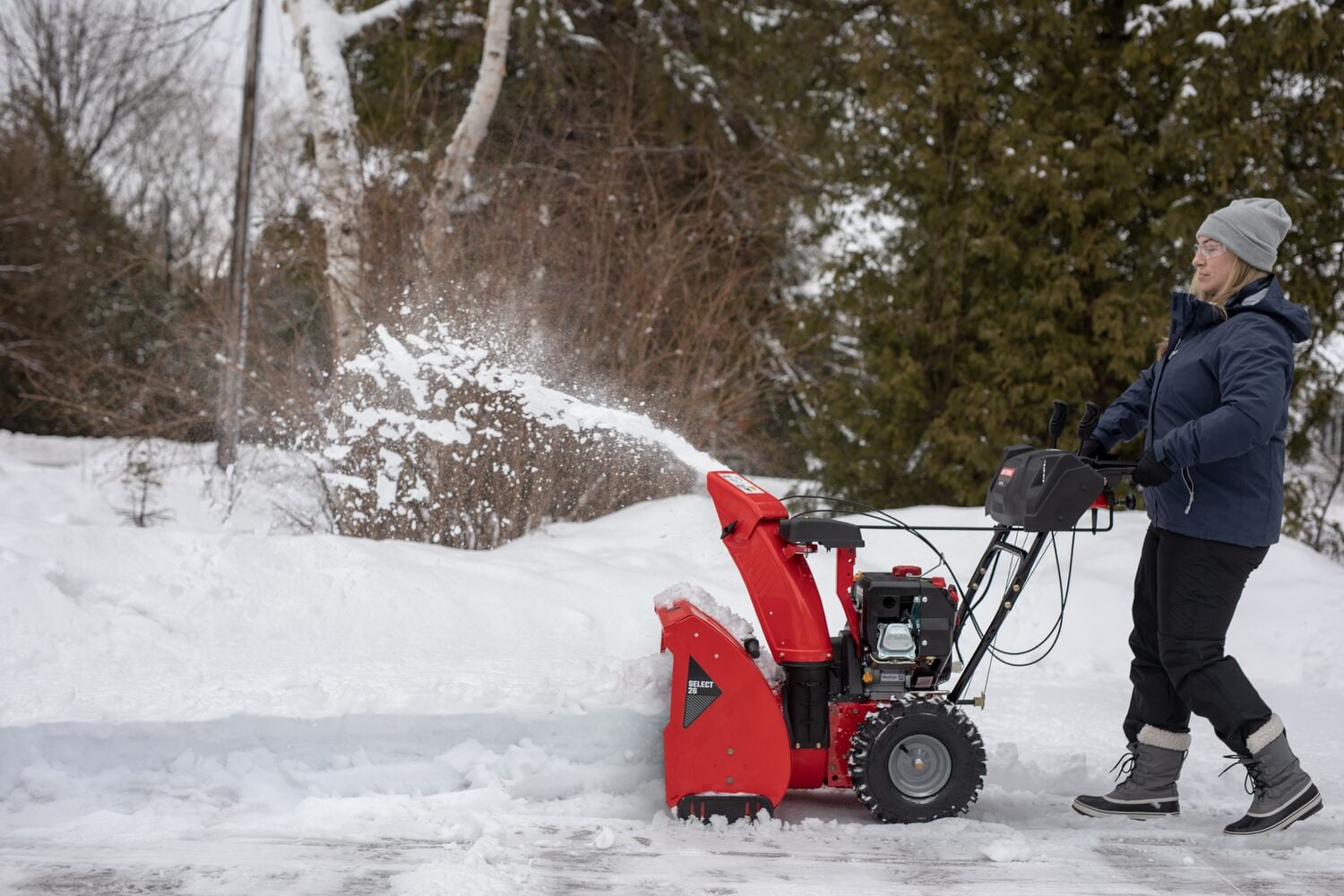 SELECT 26 inch 243 CC two stage gas snow blower with push button electric start being used.