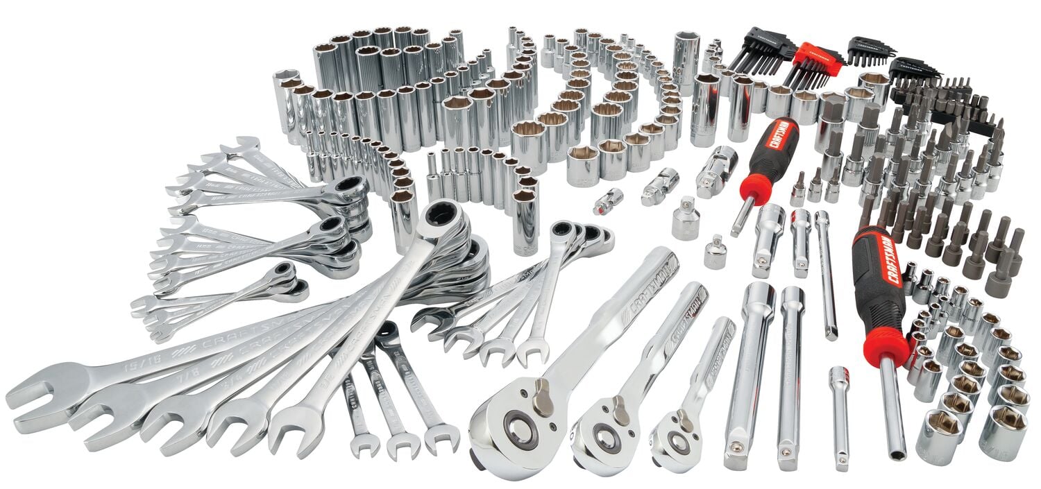 A large set of silver hand tools including wrenches, ratchets, sockets, screwdrivers, hex keys, and extension bars, neatly arranged and displayed on a white background.