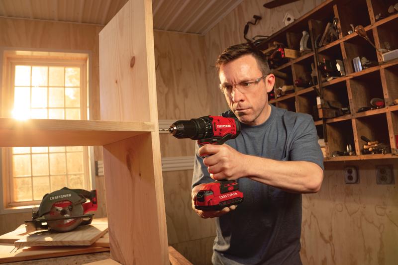 Cordless half inch drill and driver kit 1 battery being used for drilling in wood.