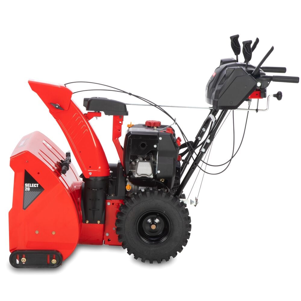 Side view of a red and black two-stage snow blower with large wheels, control panel, and chute for directing snow discharge.