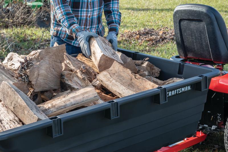 17 cubic foot poly cart being used to load wooden logs.