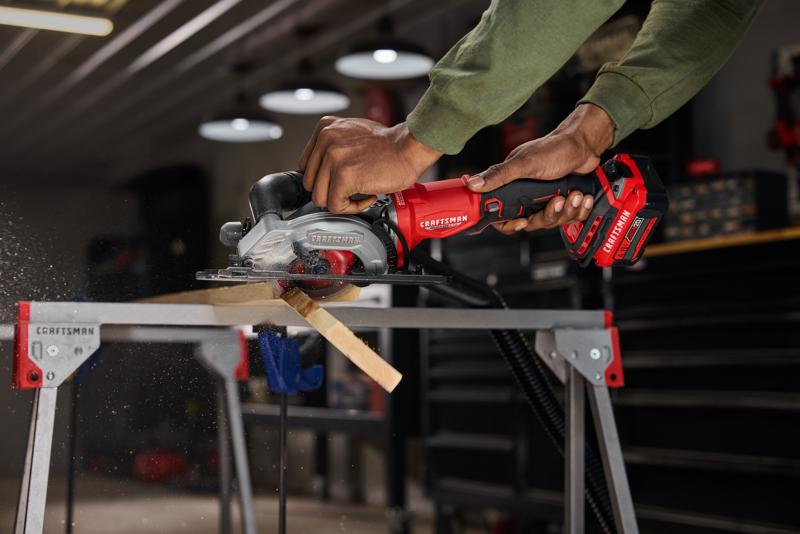 CRAFTSMAN V20* RP 4.5” Circular Saw cutting through 2x4 showing vacuum
 attachment