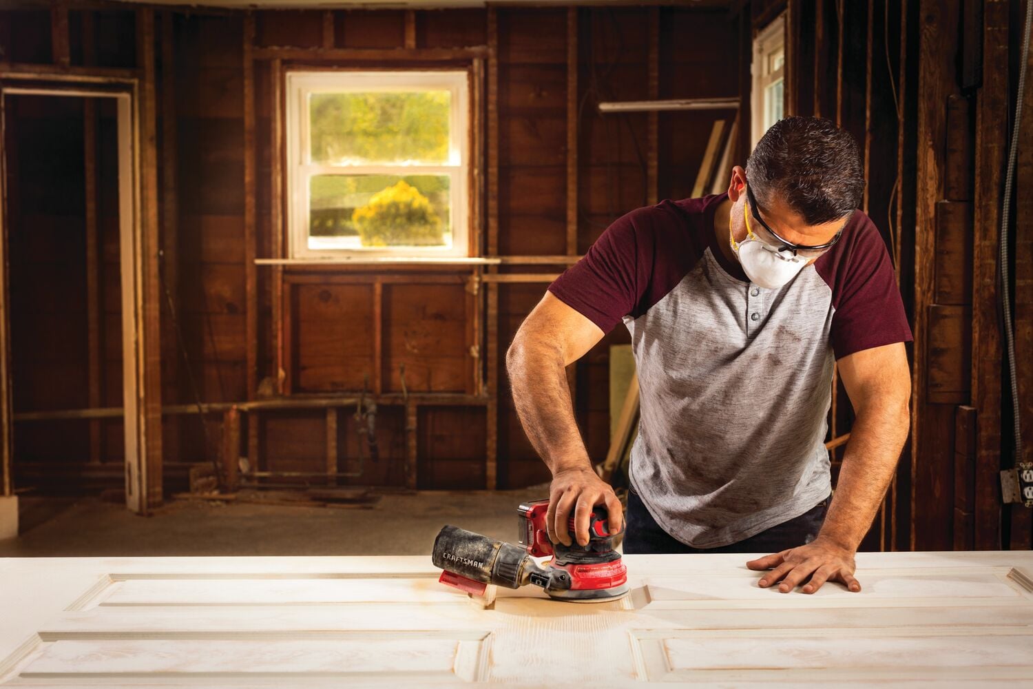 20 volt cordless random orbit sander being used by a person.