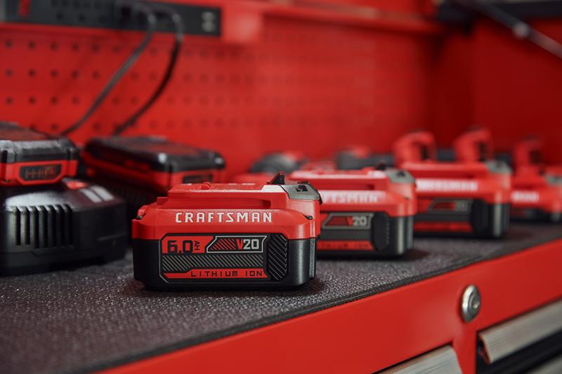 Photo of Craftsman V20 lithium ion battery CMCB206, 6.0Ah, red and black, on tool bench.