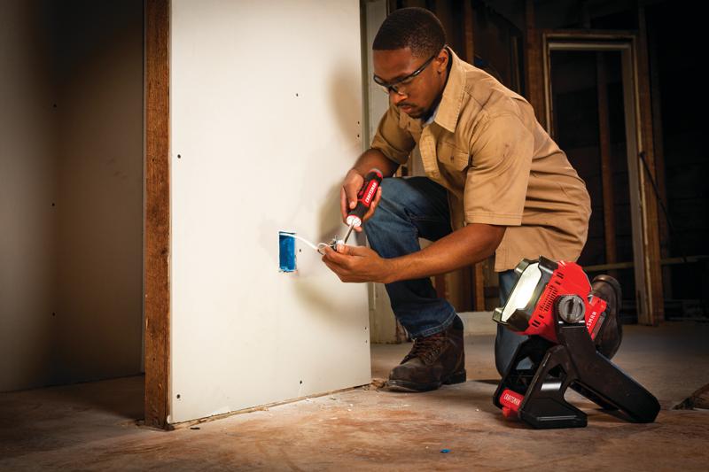 Photo of Craftsman work light CMCL030B illuminating electrician working on drywall wiring.