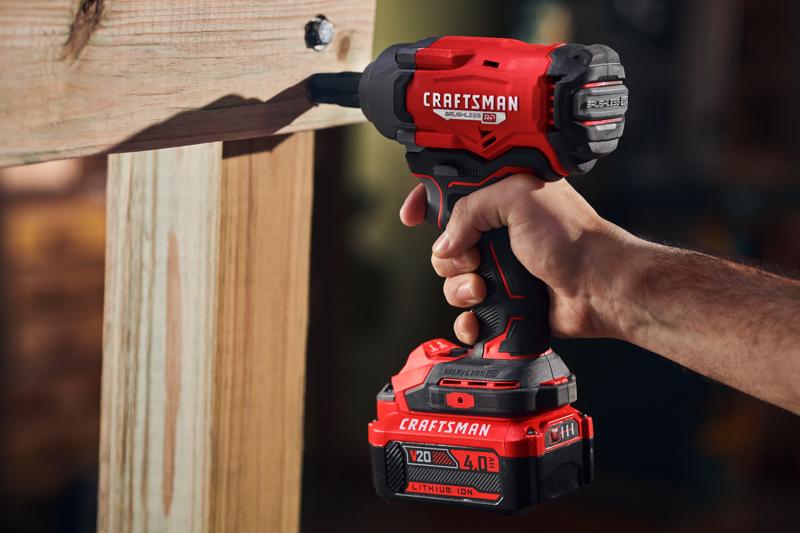 Photo of Craftsman cordless impact driver, SKU CMCF921B, in use driving a bolt into wood, handheld close-up.