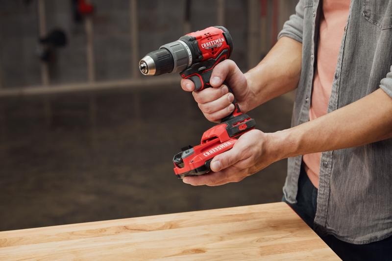 Man putting CRAFTSMAN V20* Battery into CRAFTSMAN Brushless RP Drill