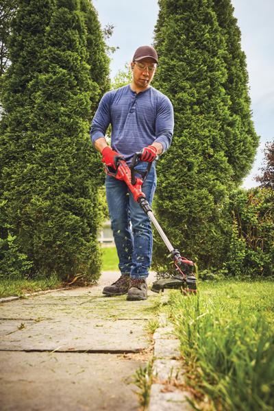 20 volt weedwacker 13 inch cordless string trimmer and edger with automatic feed kit being used by a person to cut grass outdoors.