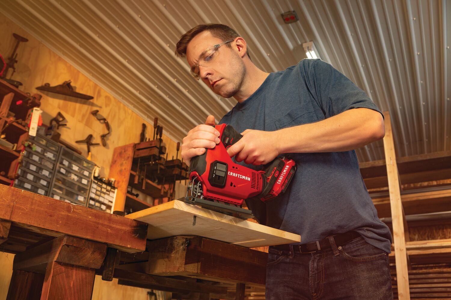 20 volt cordless jig saw kit being used by a person to cut wood indoors.