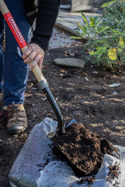 Long Handle Cleated Step Digging Shovel with wood handle and cushion grip, in action 