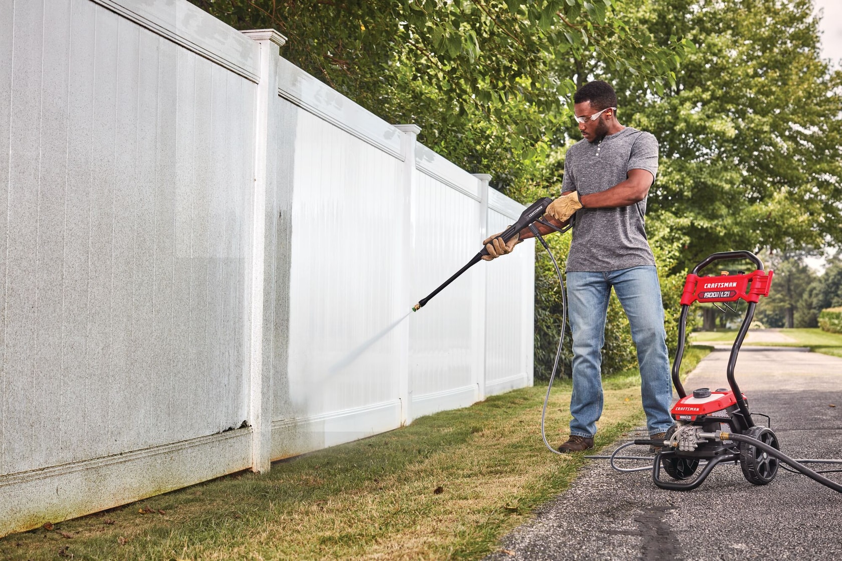 1900 pound per square inch electric cold water pressure washer being used by a person.