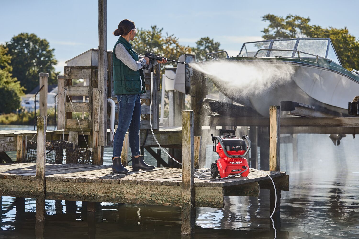 CRAFTSMAN 1500 PSI Pressure Washer washing a raised boat at pier
