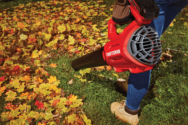 Person using CRAFTSMAN V20* Cordless Axial Leaf Blower Kit in yard
