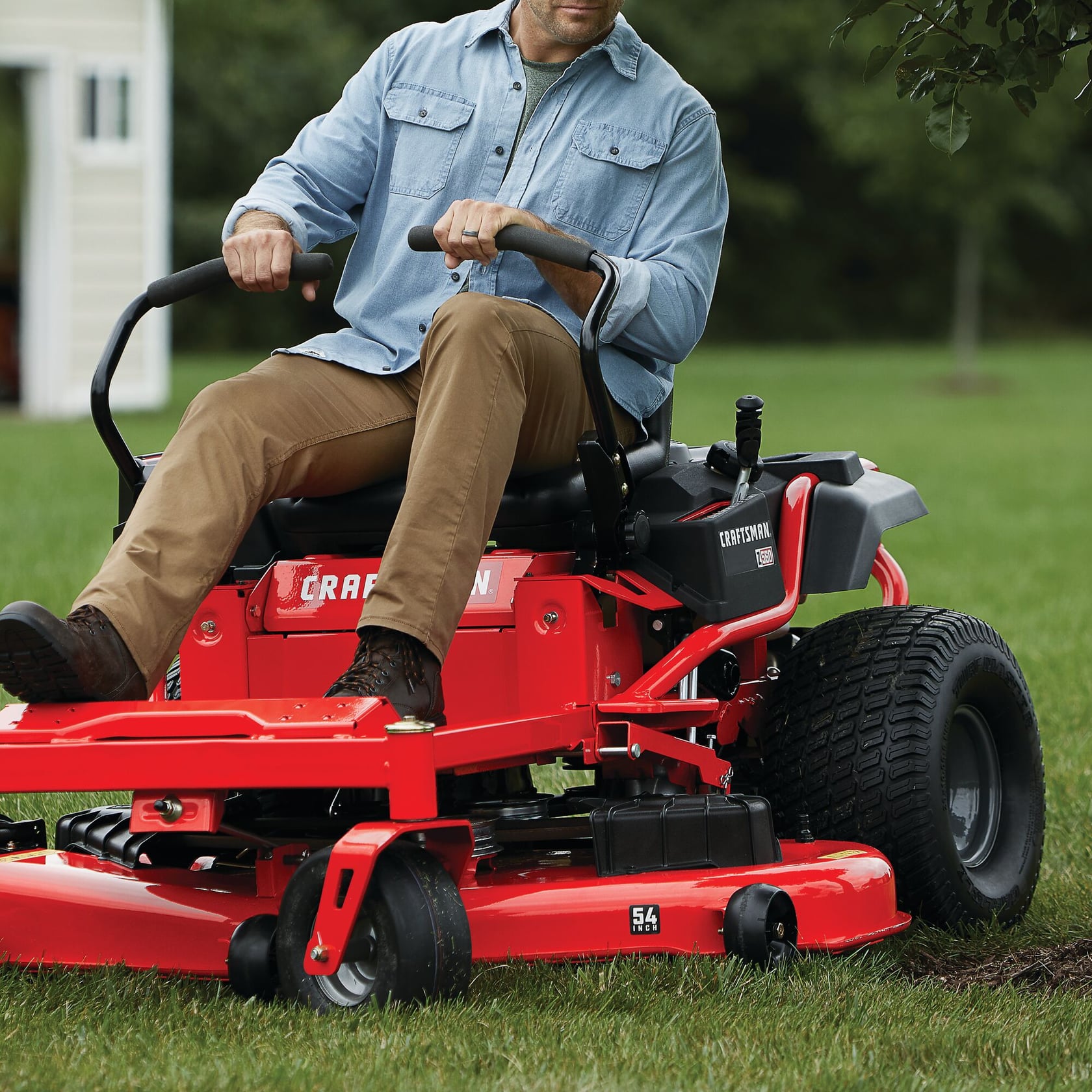 Photo of CRAFTSMAN zero-turn lawn mower CMXGNAM1130054 in use on grass, partial view of operator.