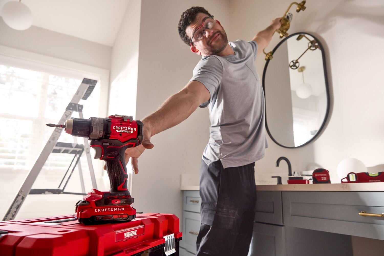 Man reaching for CRAFTSMAN V20* drill