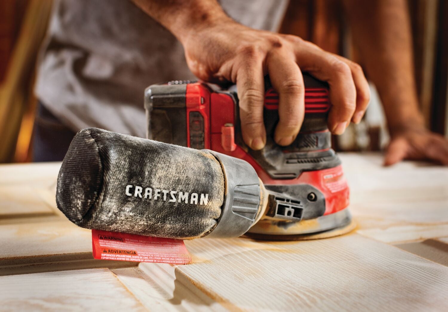 20 volt cordless random orbit sander being used .