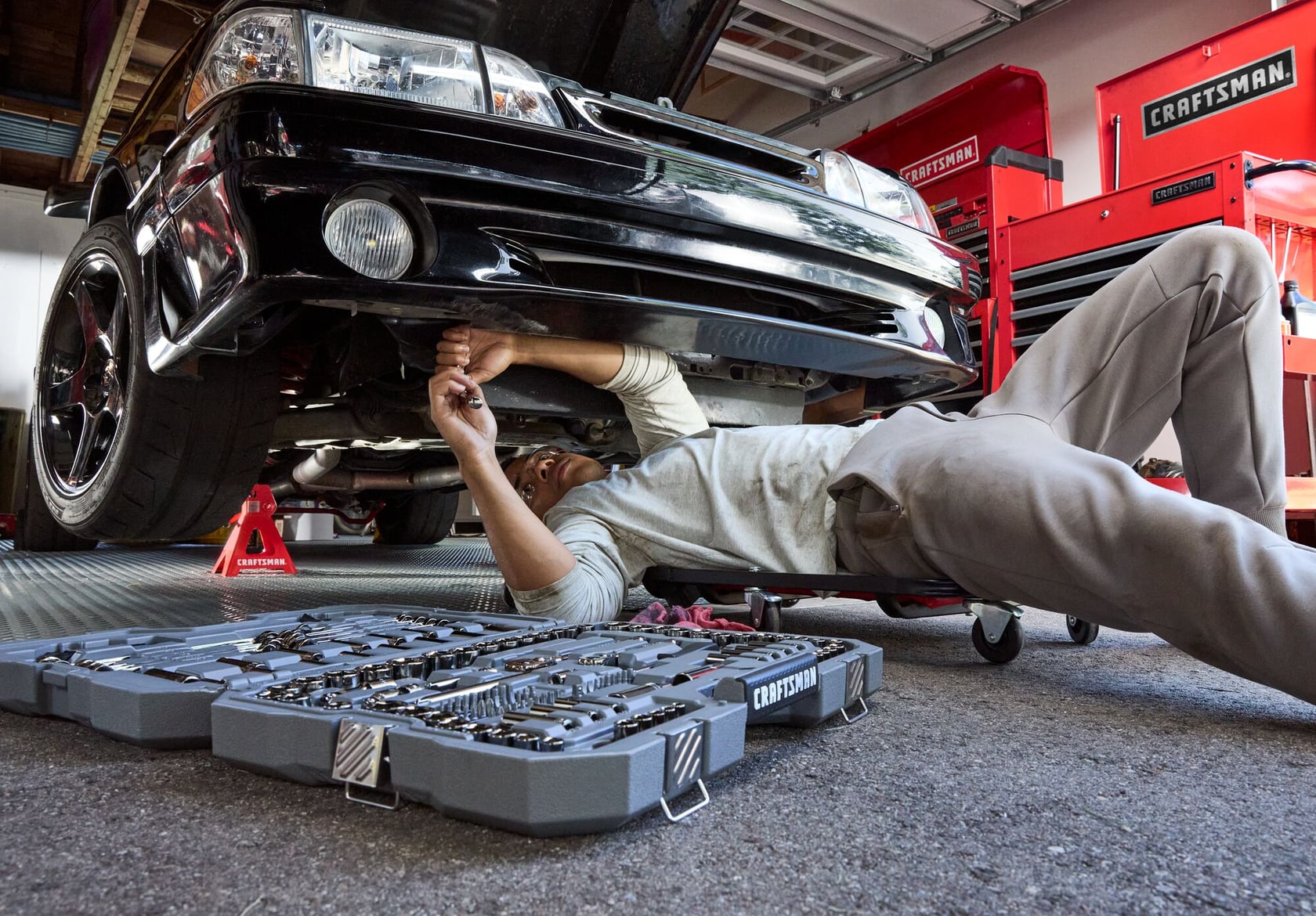 Son working with CRAFTSMAN® OVERDRIVE ™ Tools under a car