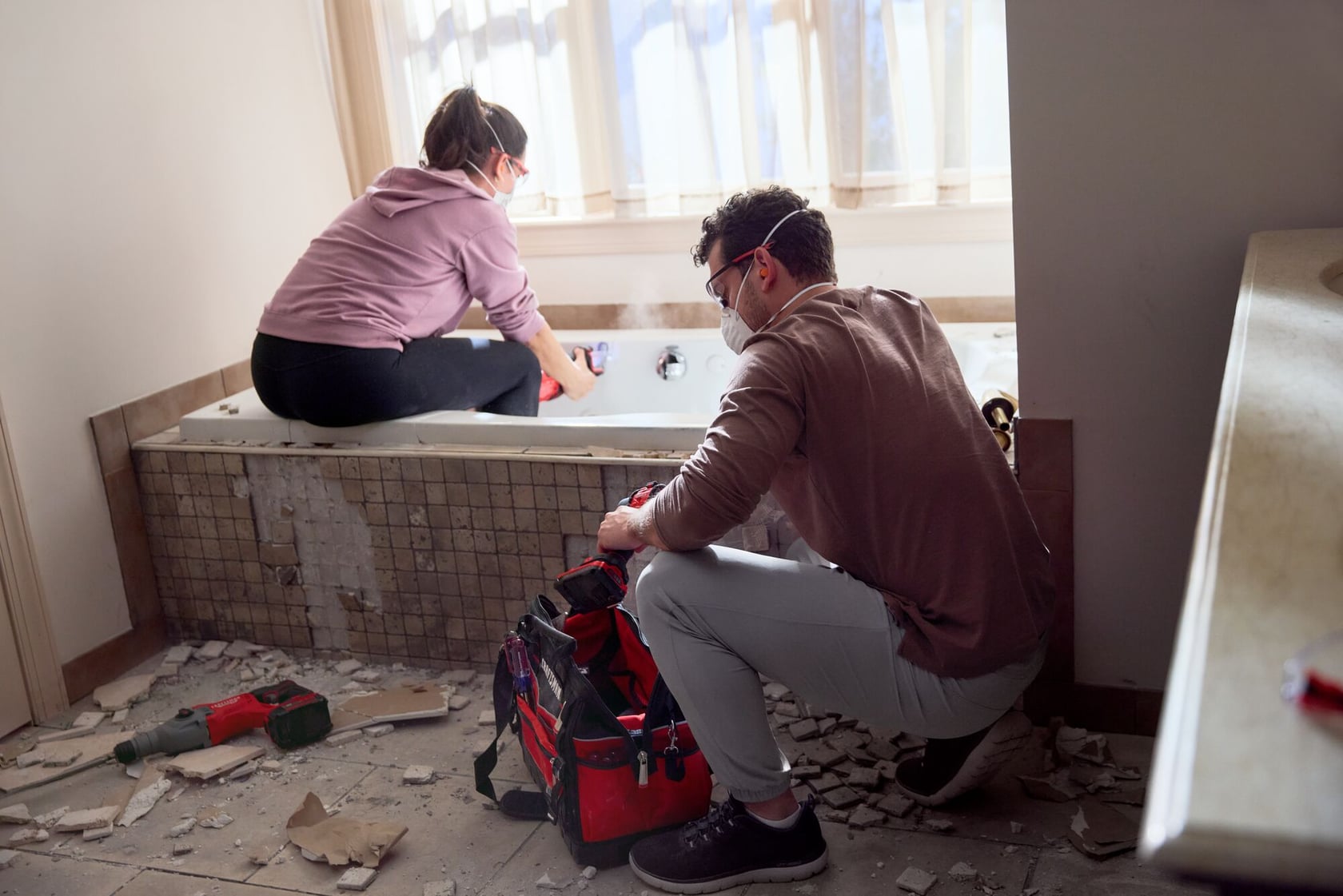Photo of CRAFTSMAN CMCS351B rotary tool with red tool bag in bathroom during renovation, debris on floor.
