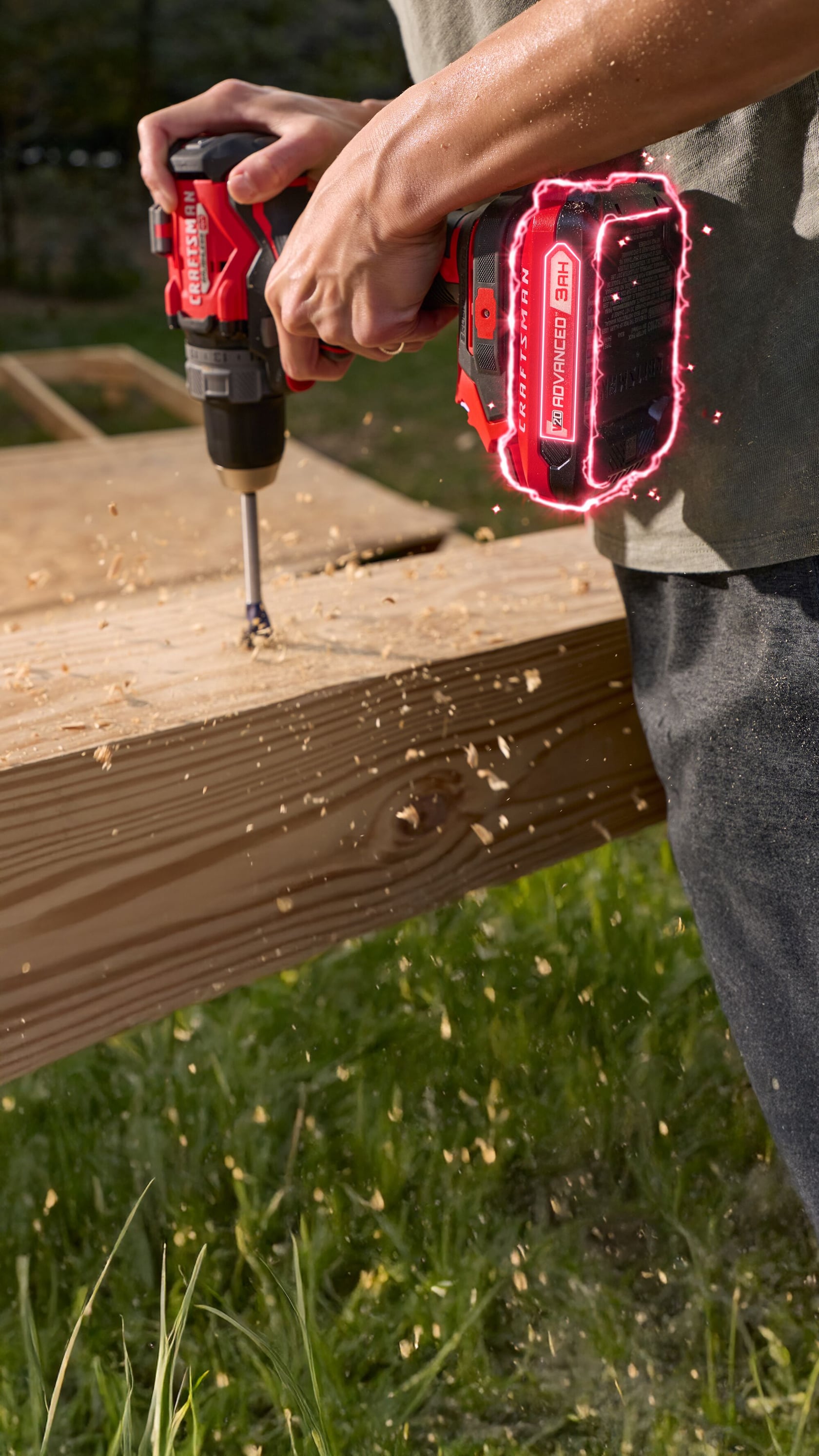 Photo of Craftsman cordless drill model CMCB202-2CRA drilling into wood outdoors, red battery visible.