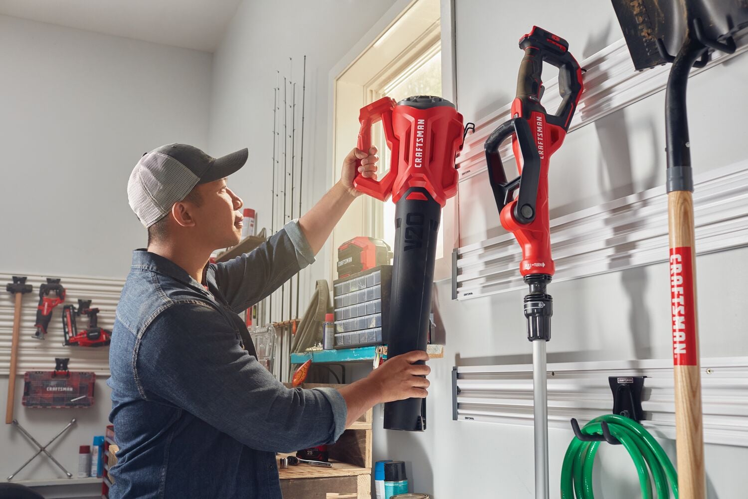 Photo of Craftsman CM_VERSA_GARAGE storage system with red power tools mounted on wall in garage.