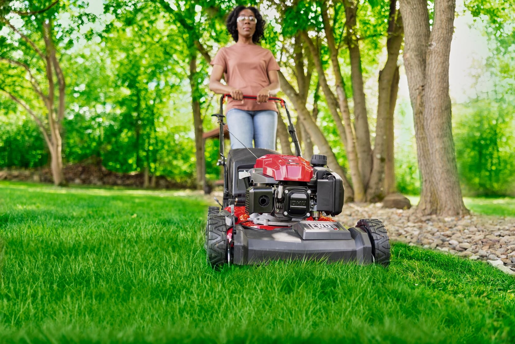 Photo of Craftsman lawn mower CM12A-A2C2093 being used on green grass in a sunny yard.