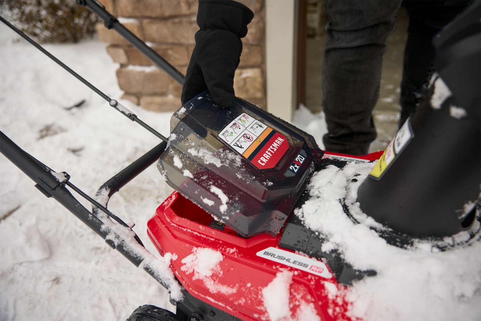 Close up opening battery compartment on CRAFTSMAN 2x20V 18" Snow Blower