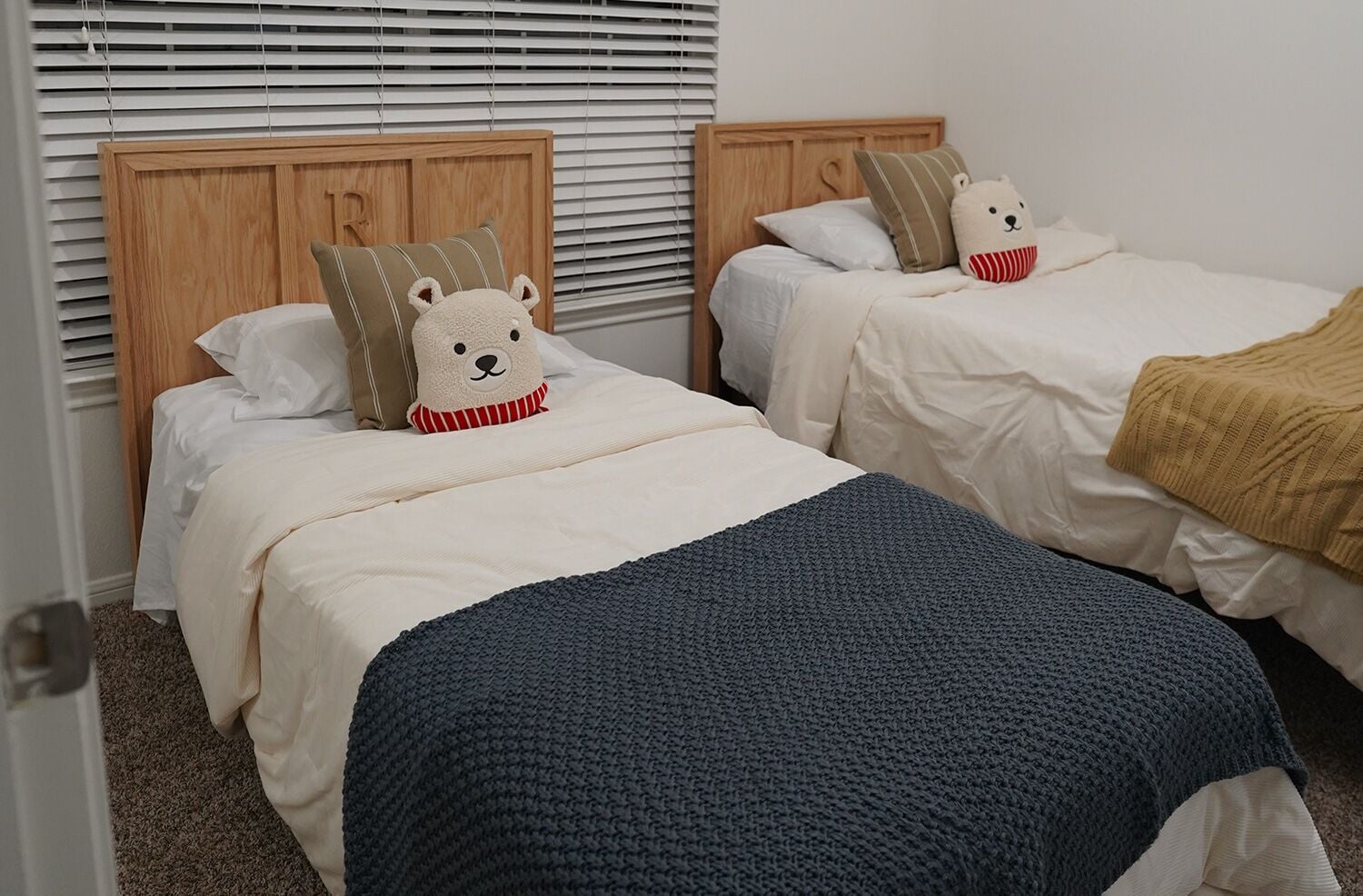 Two twin beds with a custom wooden head board