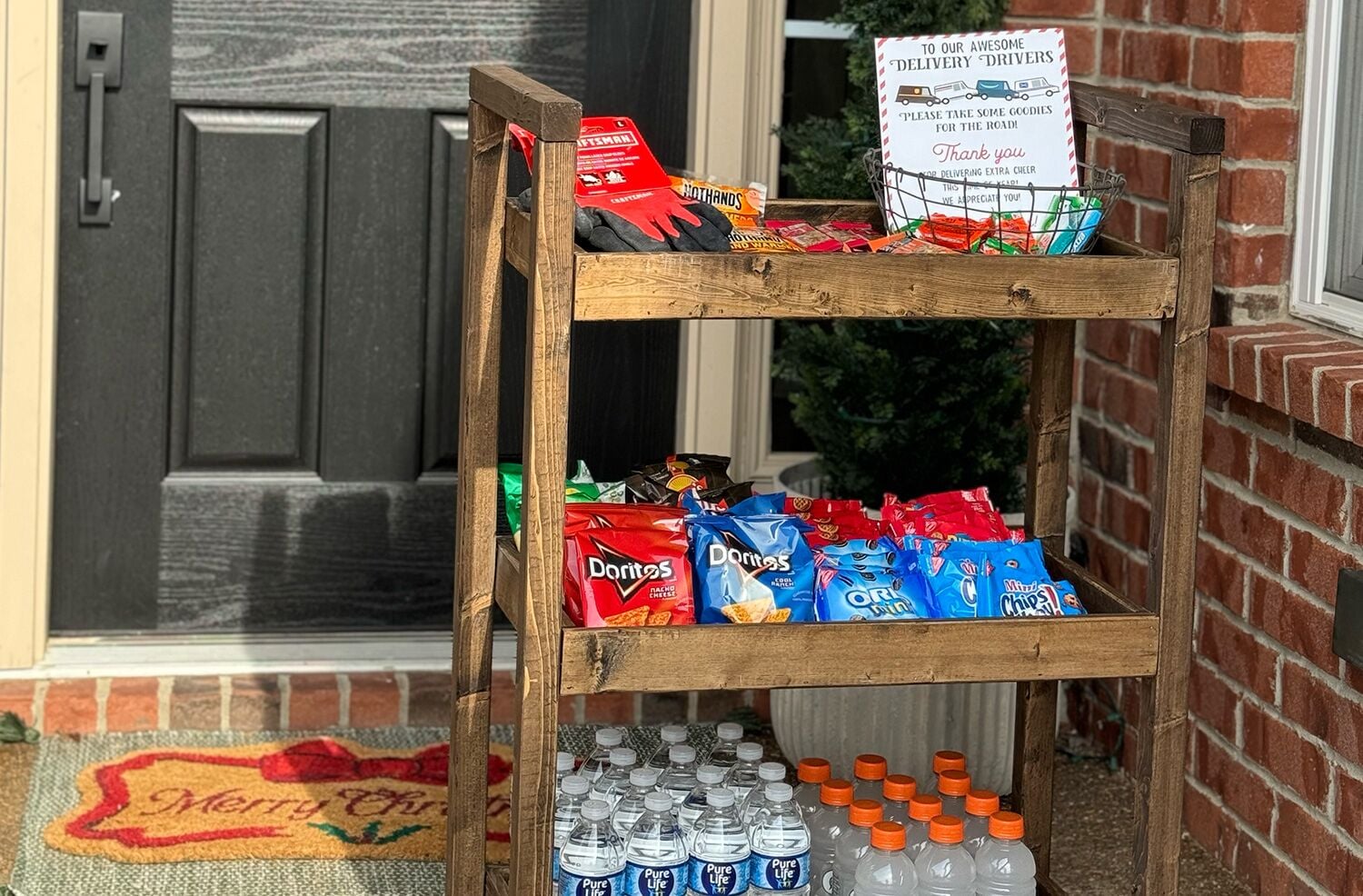 A wooden delivery driver cart filled with snacks