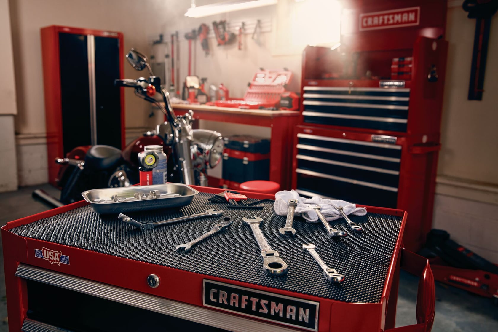 Photo of Craftsman tool chest CMMT12060 with assorted wrenches and tray on top in a workshop setting.