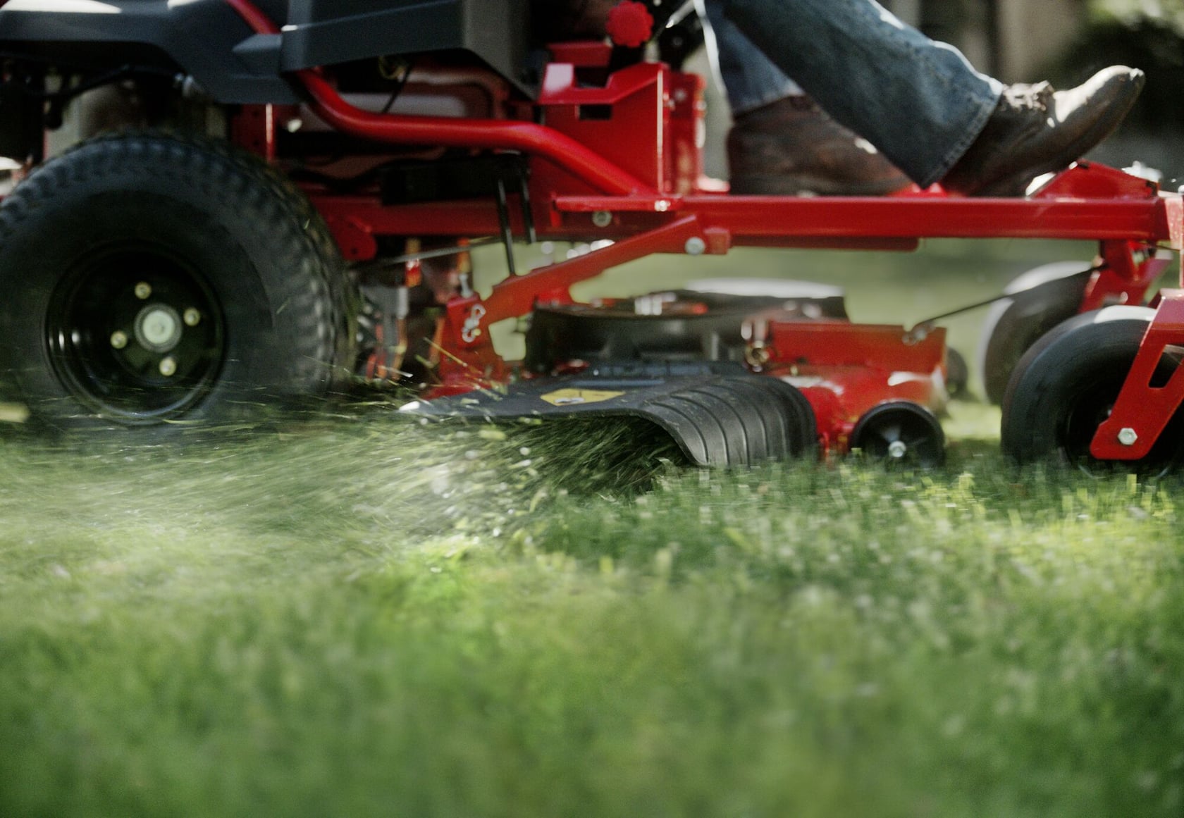 22 h p 46 inch zero turn riding mower being used to mow the lawn.