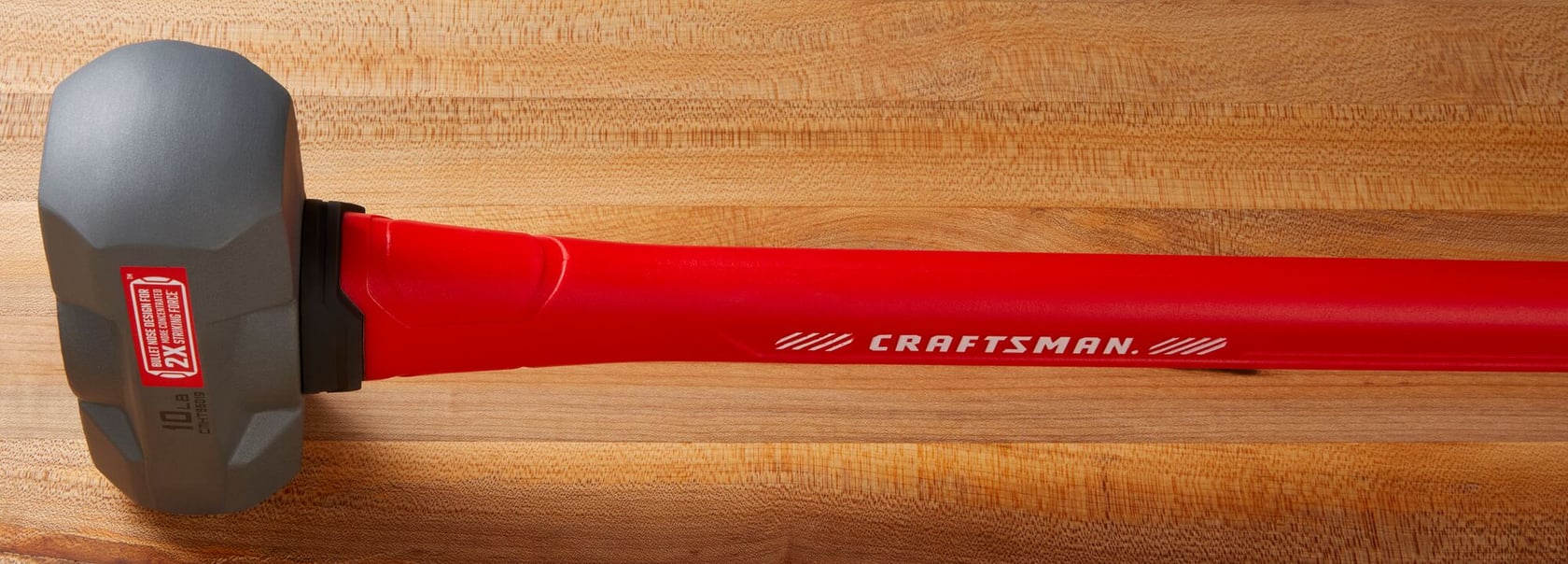 Photo of Craftsman sledge hammer with gray head and red handle, model CMHT56019, on wood surface.