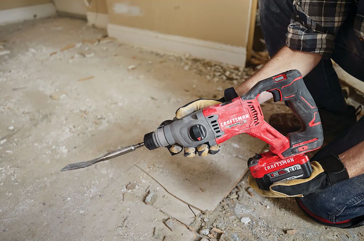 Man with gloves, respirator and safety glasses using the CRAFSTMAN V20 Brushless RP 7/8 inch SDS plus Rotary Hammer with to remove tile flooring.