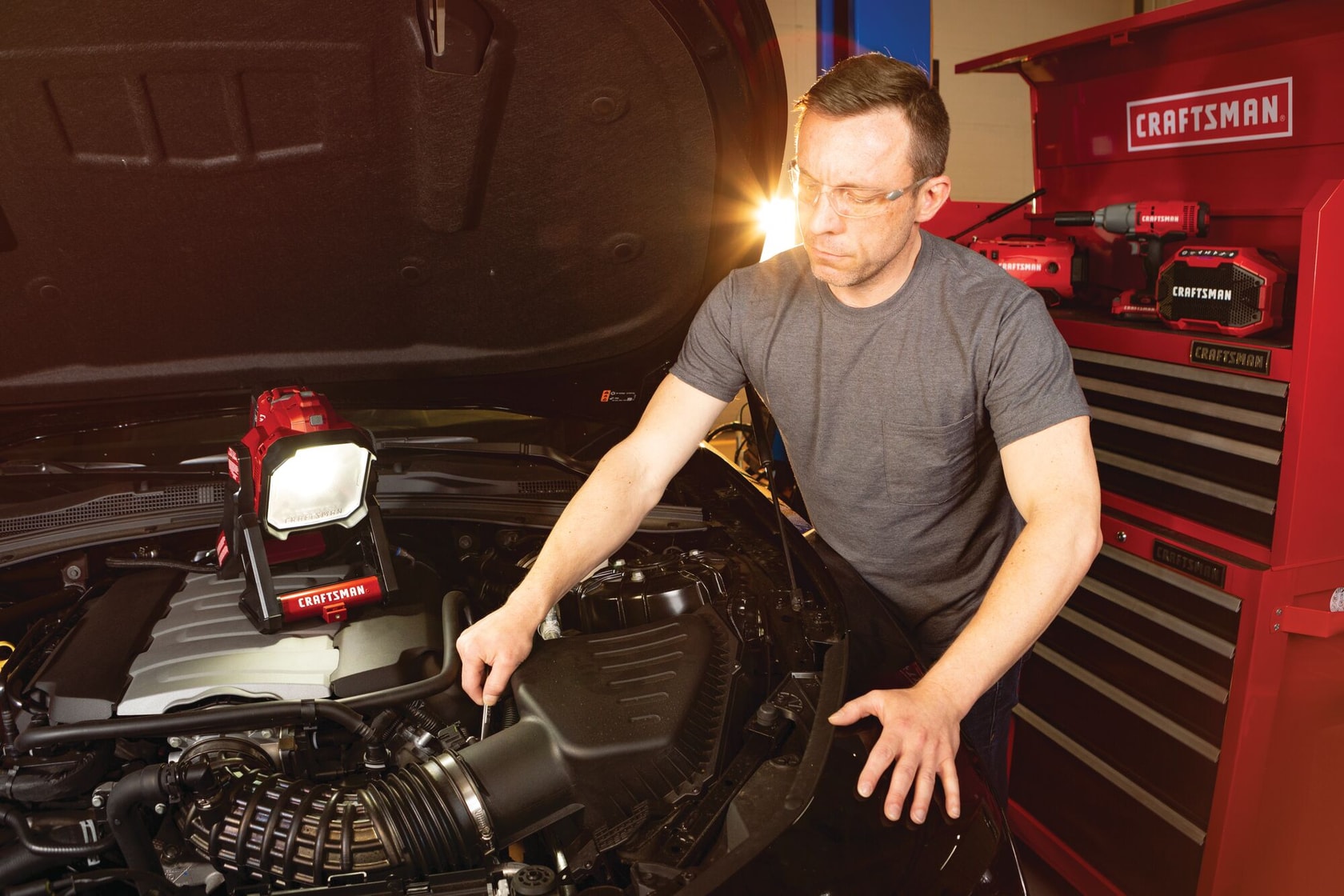 Cordless small area light tool only being used for fixing car engine.